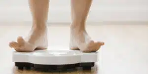 Woman's feet standing on scale